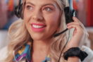 a woman wearing headphones and smiling at the camera